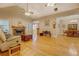 Bright living room featuring a fireplace, hardwood floors, and an open layout to the dining area at 1041 Flat Rock Rd, Covington, GA 30014