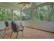 Relaxing screened porch featuring wood floors and serene views of the surrounding trees at 1041 Flat Rock Rd, Covington, GA 30014