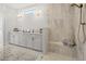 Bathroom featuring a double vanity, walk-in shower with seat, and modern fixtures at 314 Brooke View Trail, Canton, GA 30115
