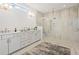 Bright bathroom with double vanity, white cabinets, and glass walk-in shower at 314 Brooke View Trail, Canton, GA 30115