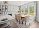 Open dining area with large windows, modern lighting, and a view of the backyard at 314 Brooke View Trail, Canton, GA 30115