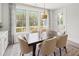 Well-lit dining area with a modern table set, complemented by large windows and views of the outdoors at 314 Brooke View Trail, Canton, GA 30115
