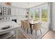 Bright dining area featuring a modern table set, elegant decor, and large windows showcasing natural light and views at 314 Brooke View Trail, Canton, GA 30115