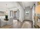 Bright dining area featuring modern light fixture, table with seating, and access to the front entry at 314 Brooke View Trail, Canton, GA 30115