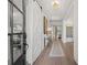 Bright foyer with hardwood floors, barn door, modern lighting, and stylish decor at 314 Brooke View Trail, Canton, GA 30115