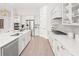 Bright kitchen featuring stainless steel appliances, island with seating, and white cabinetry at 314 Brooke View Trail, Canton, GA 30115