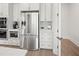 Bright, modern kitchen featuring stainless steel appliances and white cabinetry at 314 Brooke View Trail, Canton, GA 30115