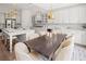 Spacious kitchen with an island and open dining area, featuring modern appliances and stylish decor at 314 Brooke View Trail, Canton, GA 30115