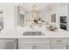 Spacious kitchen featuring stainless steel sink, quartz countertops, and view of living area at 314 Brooke View Trail, Canton, GA 30115
