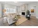Cozy living room with a stone fireplace, plush seating, and sliding doors to the outside at 314 Brooke View Trail, Canton, GA 30115