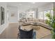 Open-concept living room with a comfortable sofa, connecting to the kitchen and featuring large windows at 314 Brooke View Trail, Canton, GA 30115