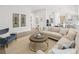 Spacious living room with a comfortable sofa, stylish decor, and an open view to the kitchen area at 314 Brooke View Trail, Canton, GA 30115