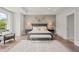 Elegant main bedroom with a tray ceiling, neutral tones, and a cozy sitting area by the window at 314 Brooke View Trail, Canton, GA 30115