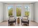 Cozy sitting area with comfortable armchairs and views of the trees through the bright windows at 314 Brooke View Trail, Canton, GA 30115