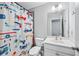 bathroom featuring a vibrant airplane-themed shower curtain, white vanity, and bright lighting at 350 Provenance Dr, Atlanta, GA 30328