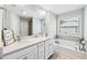 Bright bathroom with double sinks, soaking tub, and modern fixtures at 350 Provenance Dr, Atlanta, GA 30328