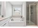 Bathroom featuring a soaking tub with jets and a glass enclosed shower at 350 Provenance Dr, Atlanta, GA 30328