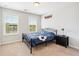 Neutral bedroom featuring two windows, carpeted floors, and a playful soccer-themed bedspread at 350 Provenance Dr, Atlanta, GA 30328