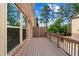 Spacious wooden deck with brick siding, overlooking the yard and trees at 350 Provenance Dr, Atlanta, GA 30328