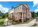 Charming townhome exterior with stone and brick facade, manicured landscaping, and inviting walkway at 350 Provenance Dr, Atlanta, GA 30328