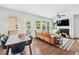 Cozy living room area with fireplace, large windows, and hardwood flooring at 350 Provenance Dr, Atlanta, GA 30328
