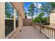 Exterior shot of a private patio featuring brown wood decking and brick wall at 350 Provenance Dr, Atlanta, GA 30328