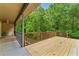 Large wooden deck overlooks a private, wooded backyard, creating a serene outdoor living space at 418 Whisper Wood Way, Locust Grove, GA 30248