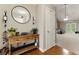 Inviting entryway with wooden floors, complemented by a rustic table and bright, open living space at 418 Whisper Wood Way, Locust Grove, GA 30248