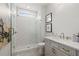 Modern bathroom features a glass shower with white subway tile, marble vanity, and attractive gold fixtures at 753 Brooke View Drive, Canton, GA 30115