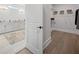 Bright bathroom featuring a double sink vanity and a walk-in closet with ample storage space at 753 Brooke View Drive, Canton, GA 30115
