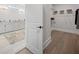 Bathroom featuring a dual sink vanity with gold fixtures and a walk-in closet at 753 Brooke View Drive, Canton, GA 30115