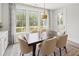 Bright dining room features a modern table, stylish chairs, and large windows with outdoor views at 753 Brooke View Drive, Canton, GA 30115