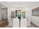 Formal dining room boasts modern chandelier and neutral color palette at 753 Brooke View Drive, Canton, GA 30115