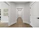 Bright hallway with wood floors, white trim, and doorways leading to other rooms in the house at 753 Brooke View Drive, Canton, GA 30115