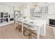 This spacious kitchen includes a large island with seating, stainless appliances, and white cabinets at 753 Brooke View Drive, Canton, GA 30115