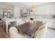 Open floor plan features a kitchen island, dining area, and stainless steel appliances at 753 Brooke View Drive, Canton, GA 30115