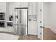 Modern kitchen with stainless steel appliances, white cabinetry, and breakfast nook at 753 Brooke View Drive, Canton, GA 30115