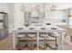 Bright kitchen with white cabinets, center island with seating, and stainless appliances at 753 Brooke View Drive, Canton, GA 30115
