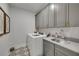 Laundry room boasts gray cabinets, patterned tile floors, a large sink, and a new washer and dryer at 753 Brooke View Drive, Canton, GA 30115