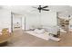 Open-concept living room with hardwood floors, neutral decor, and a modern ceiling fan at 753 Brooke View Drive, Canton, GA 30115
