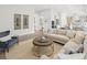 Open concept living room showcases a modern kitchen, comfortable sofa, and stylish decor at 753 Brooke View Drive, Canton, GA 30115