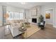 Cozy living room boasts a stone fireplace, plush seating, and plenty of natural light at 753 Brooke View Drive, Canton, GA 30115