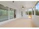 Spacious screened-in porch features wood flooring, ceiling fans, and views of the backyard and trees at 753 Brooke View Drive, Canton, GA 30115