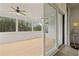 Relaxing screened-in porch with wood flooring, ceiling fans, and views of the surrounding wooded area at 753 Brooke View Drive, Canton, GA 30115