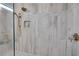 Modern bathroom shower featuring elegant tile work, gold fixtures, and a built in niche at 753 Brooke View Drive, Canton, GA 30115