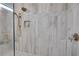 Close up of a large shower featuring bronze fixtures, a built-in niche, and decorative tile at 753 Brooke View Drive, Canton, GA 30115