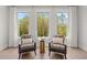 Bright sitting area with comfortable chairs, soft pillows, and a scenic view from large windows at 753 Brooke View Drive, Canton, GA 30115