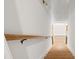 Wooden staircase leading to the lower level, featuring a modern handrail and clean white walls at 753 Brooke View Drive, Canton, GA 30115