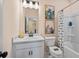 Bathroom with modern vanity, framed art, and a shower-tub combo with a stylish curtain at 22 Jacobs Farm Ln # 11, Lawrenceville, GA 30045