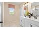 Bright bathroom with double sink vanity, modern fixtures, and a window for natural light at 22 Jacobs Farm Ln # 11, Lawrenceville, GA 30045